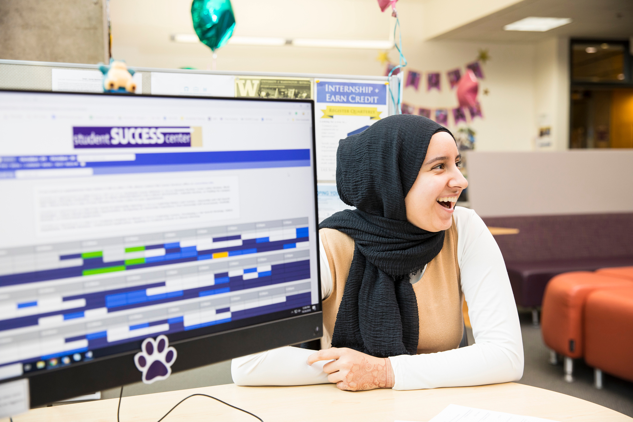 A student looks at a monitor with a success plan displayed.